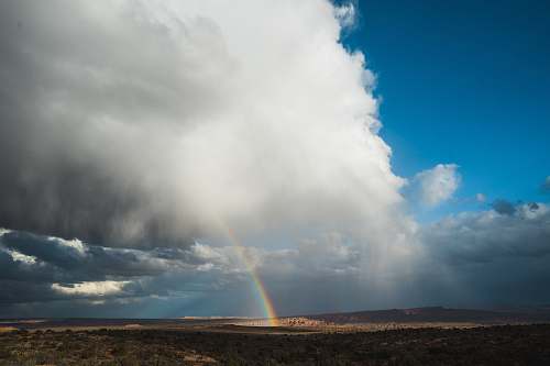 united states rainbow under cloudy skies moab
